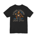 Black t-shirt with a graphic of a bear on a motorcycle and text 'Living Legend Ride Free' on the back.
