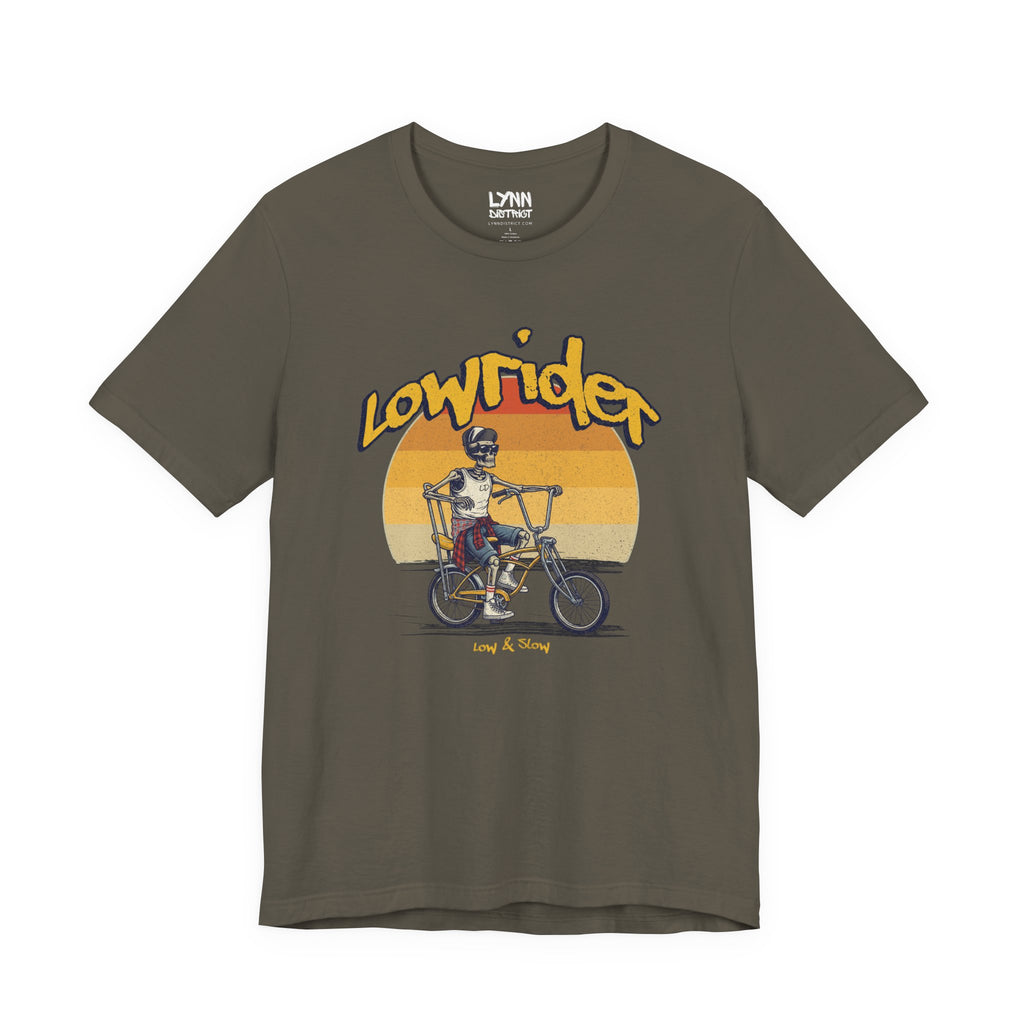 Green t-shirt with 'Lowrider' graphic design featuring a skeleton on a bike against a sunset background.